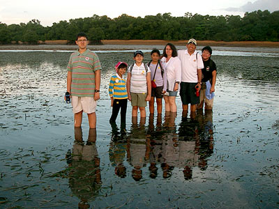 Dr Yaacob Ibrahim, Minister for the Environment and Water Resources, Singapore, with family and friends crossing the seagrass lagoon.